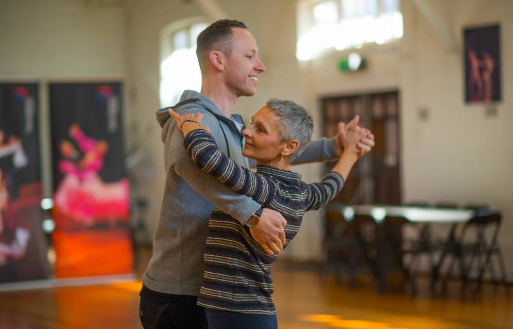 DANCING SHOES: Belinda Motton taking a twirl with Tasmanian Open DanceSport Championship event organiser Andrew Palmer. Picture: Scott Gelston