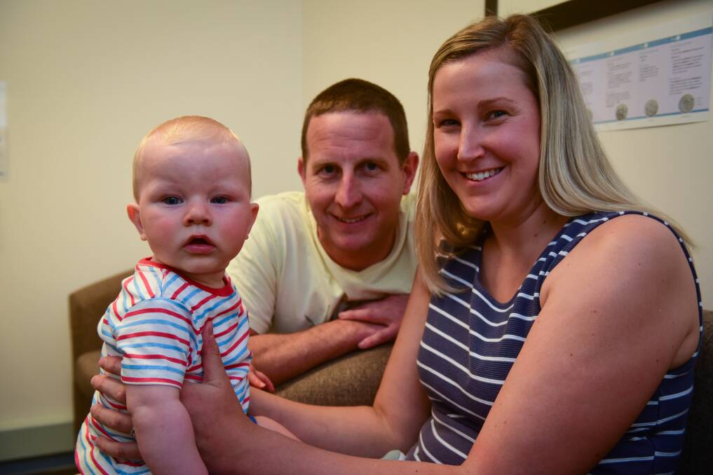 HAPPY FAMILY: Seven-month-old Oscar with his parents Adam and Jess Pearton at TasIVF. Picture: Paul Scambler