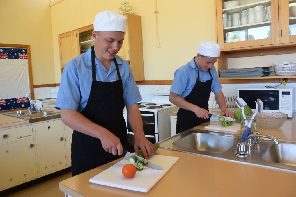 COOKING UP A STORM: Deloraine High School year 9 students Jayden Lee and Waylon Tatnell preparing some vegetables grown in the community garden. Picture: Carly Dolan