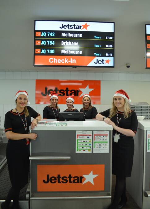 Jetstar staff Sienna, Courtney, Sharni, Shari and Ellie were on hand on Christmas Day. Picture: Adam Holmes