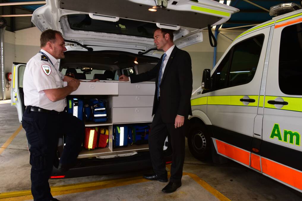 Extended Care Paramedic Glenn Aslin and the Minister of Health Michael Ferguson look over the new vehicle