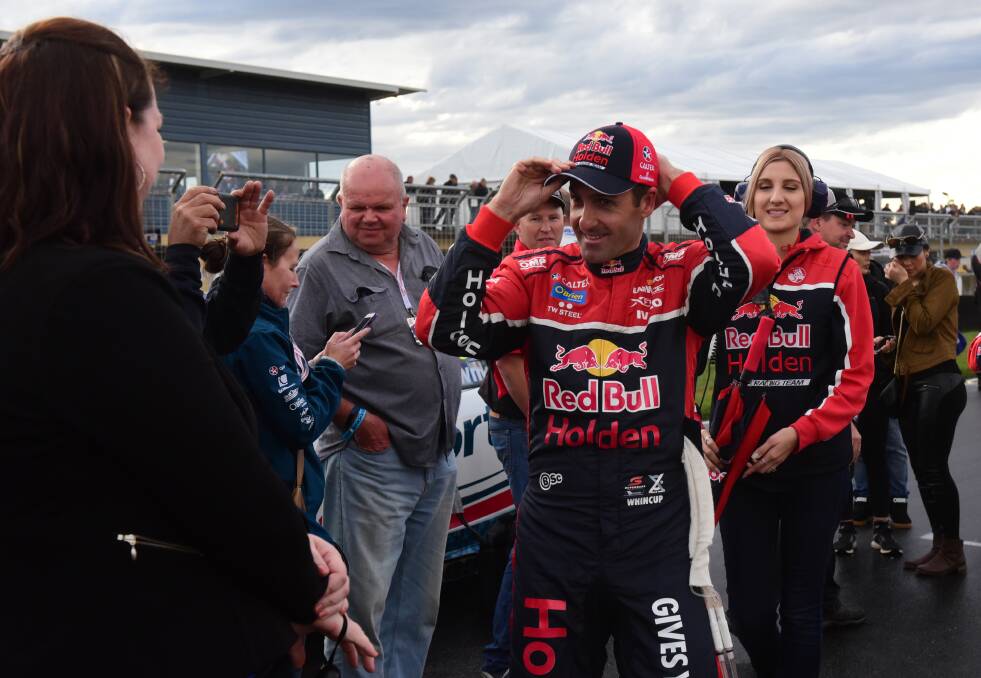 Jamie Whincup meets some fans on the grid before the drama of the Supercars race.