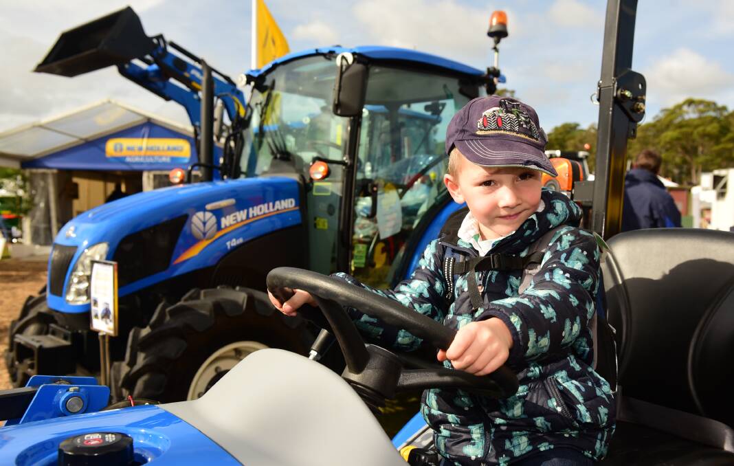 Tom Bowman, 5, of Deloraine, tries out some of the machinery.