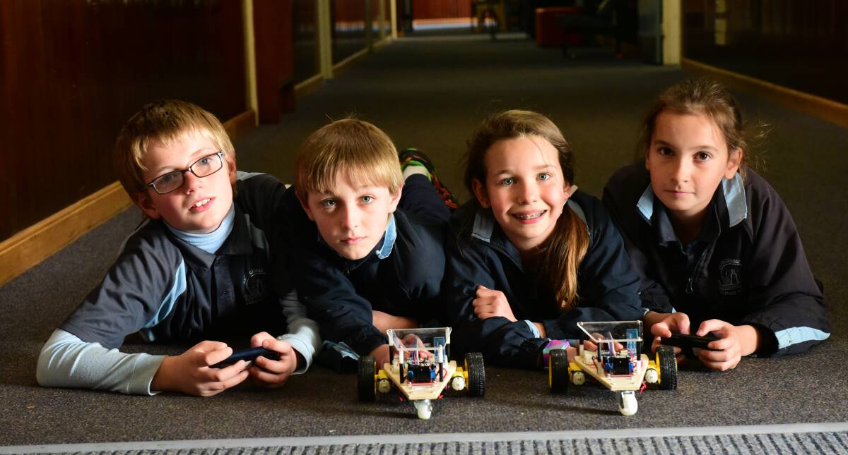 ENGAGED: South George Town primary students Mattias Schenk, Connor Lord, Amber Webb and Lily Andjelkovic with their robots. Picture: Paul Scambler
