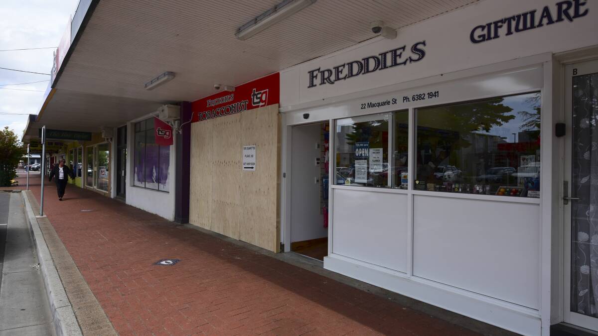 RAM RAID: Four masked offenders used a stolen car to break into Freddies Tobacconist in Macquarie Street at George Town this week. 