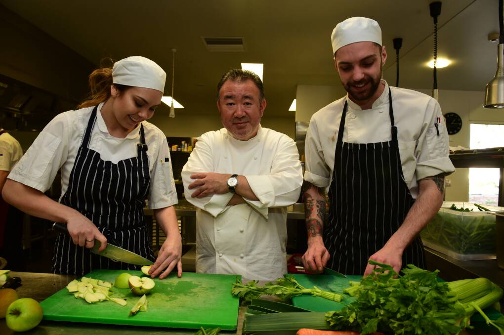 PLATE UP: Aimee Woods, a final year apprentice at Lost Farm Barnbougle with chef Tetsuya Wakuda and Brad Cubit, a third year apprentice at Cafe Culture. Picture: PAUL SCAMBLER