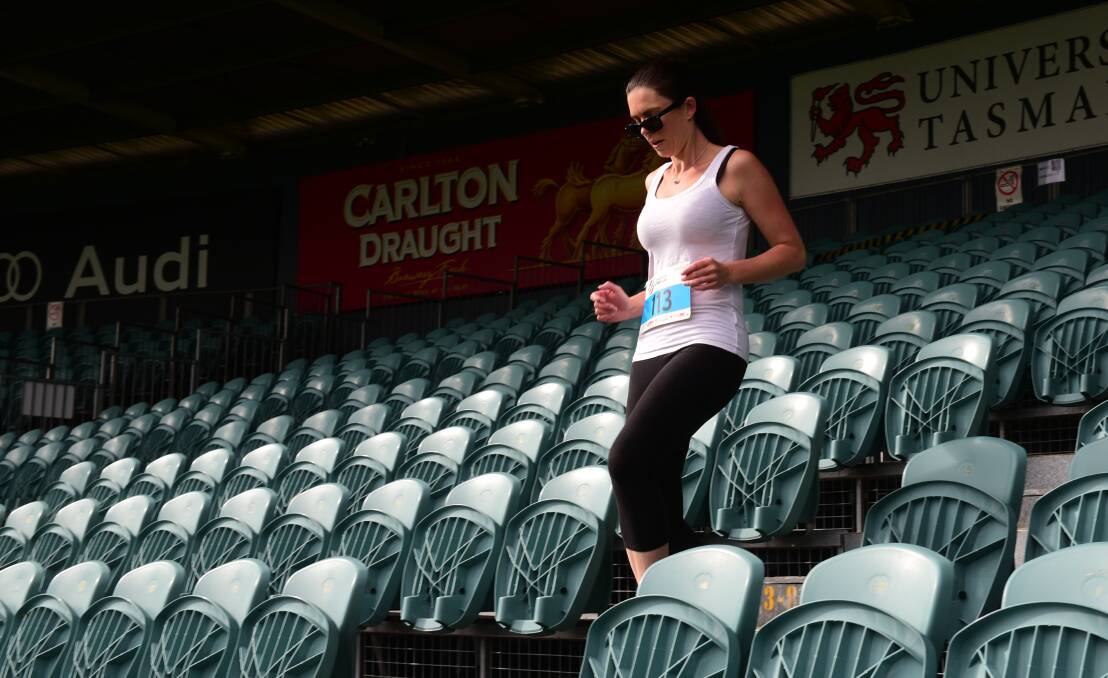 Up and down: Jodie Smith, of Launceston, heads down the steps at UTAS Stadium in one of her many laps around the course.