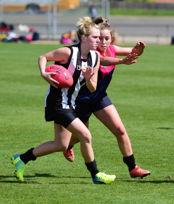 POSSESSION: Queechy's  Hayley Breward moves in to stop Scottsdale's Teigan Hill in their game at the girls' gala football day. Pictures: Paul Scambler