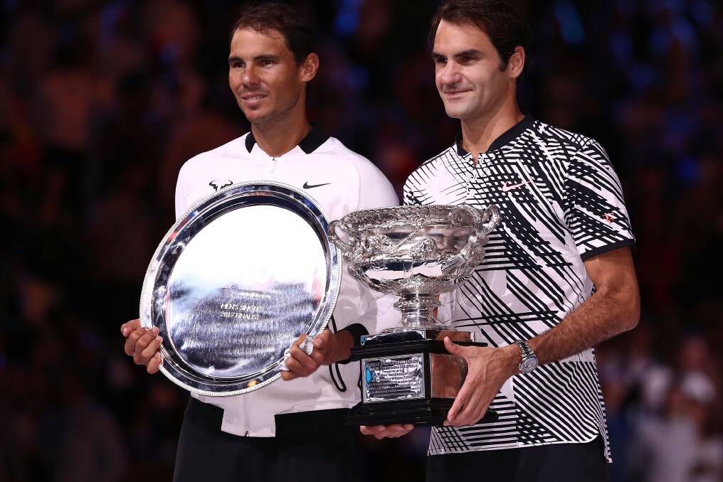 CHAMPIONS: Switzerland's Roger Federer holds the 2017 Australian Open trophy next to Spanish runner-up Rafael Nadal after a thrilling five-set, men's singles final. Picture: Getty Images