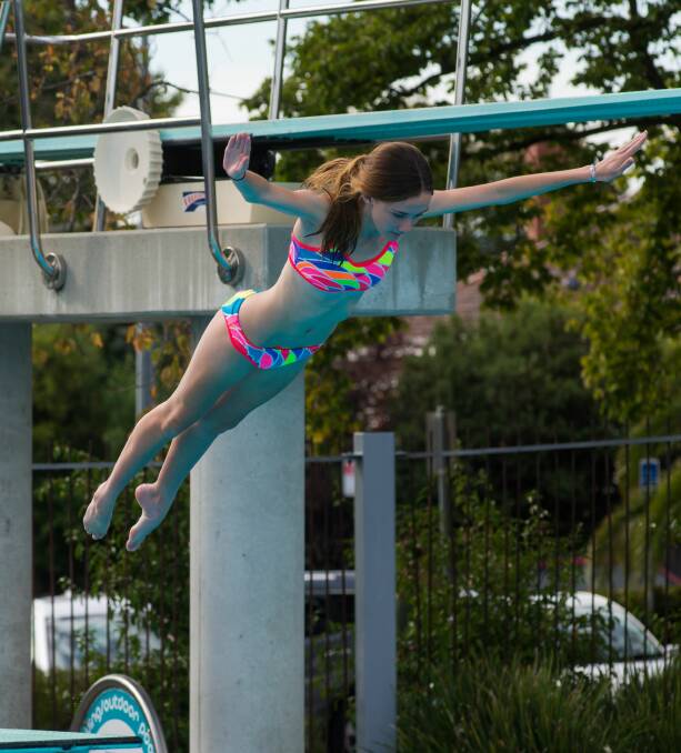 FLYING: Aisling White, of Kings Meadows, soars in the grade 9 girls' section of the Inter-High diving carnival at Launceston Aquatic. Pictures: Phil Biggs
