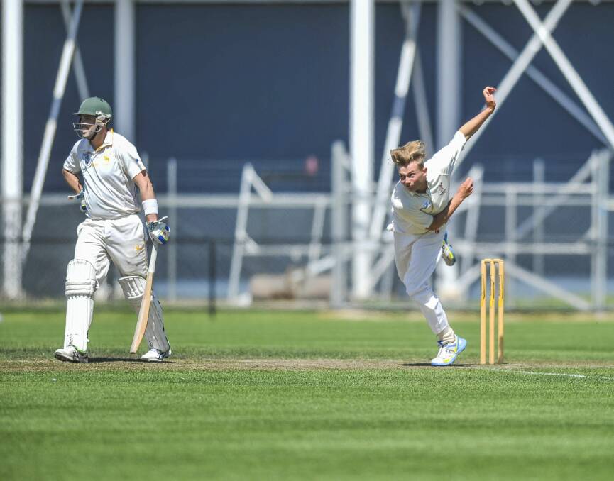 Mowbray's Adrian Loane in mid-delivery stride as he bowls to the South batsman.