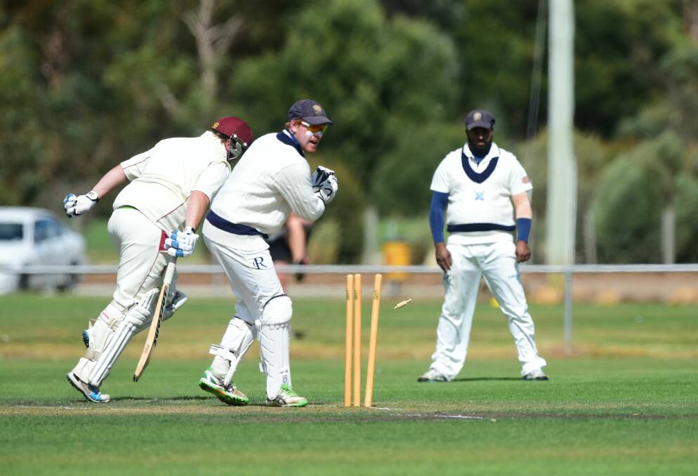 Riverside wicket-keeper Pete New takes off the bails as he attempts to run out Westbury's Kieran Hume.