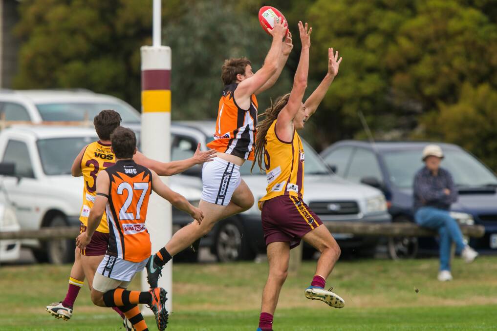 TOO GOOD: East Coast Swans player Nicholas Child marks strongly from behind over his Uni-Mowbray opponent. Picture: Phil Biggs