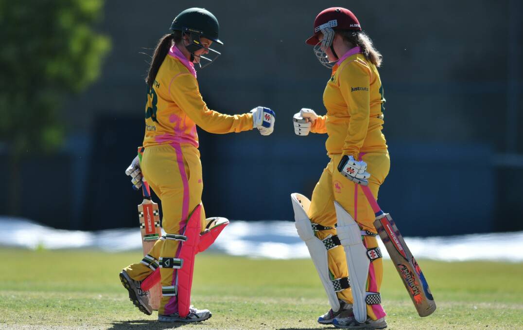 TEAMWORK: South Launceston batters Stacey Norton-Smith and Caitlyn Webster fist bump mid-pitch during a game against Ulverstone at NTCA No.2 Ground. Picture: Scott Gelston