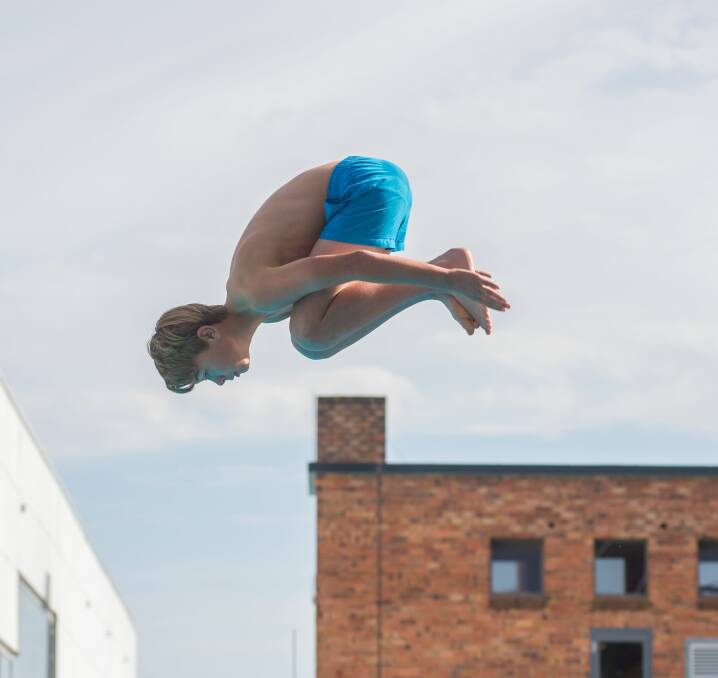 Thomas Lily, of Riverside High School, somersaults in the grade 8 boys' competition.