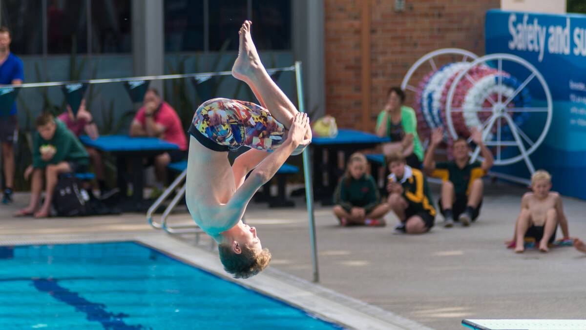 Kaiden Page, of Kings Meadows High, gets upside down in his event.