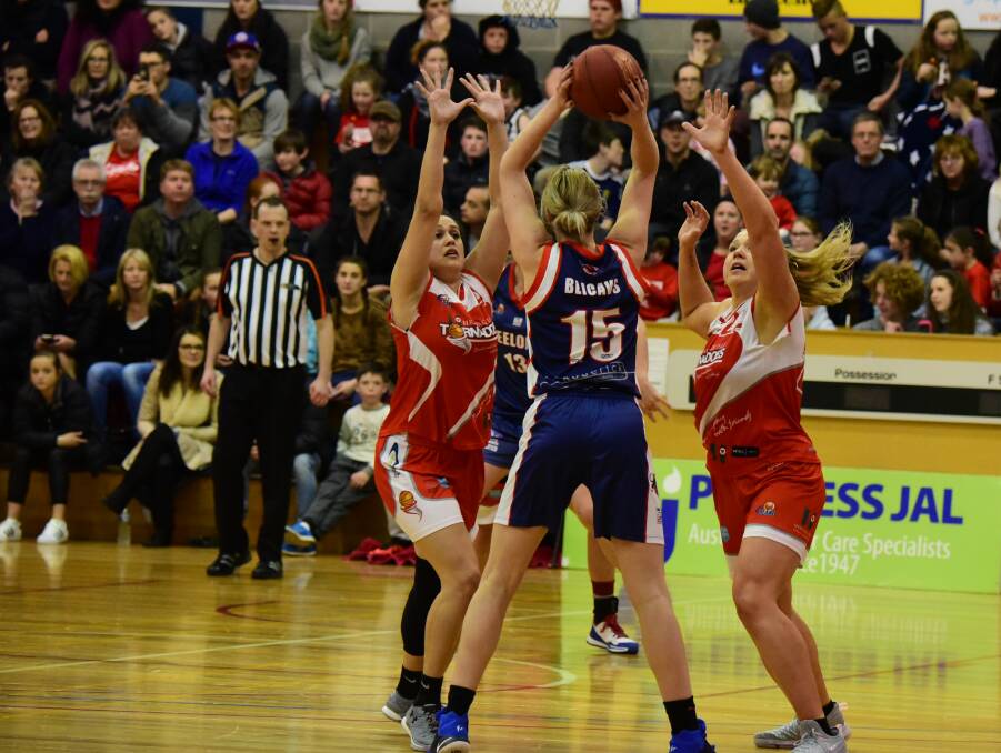 DOUBLE TAG: Launceston Tornadoes players Ally Wilson and Tayla Roberts defend against Geelong's Sara Blicavs.
