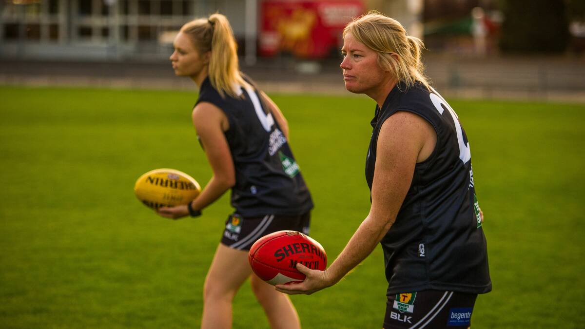Kate Child and Daria Bannister get in some handball practice at training.