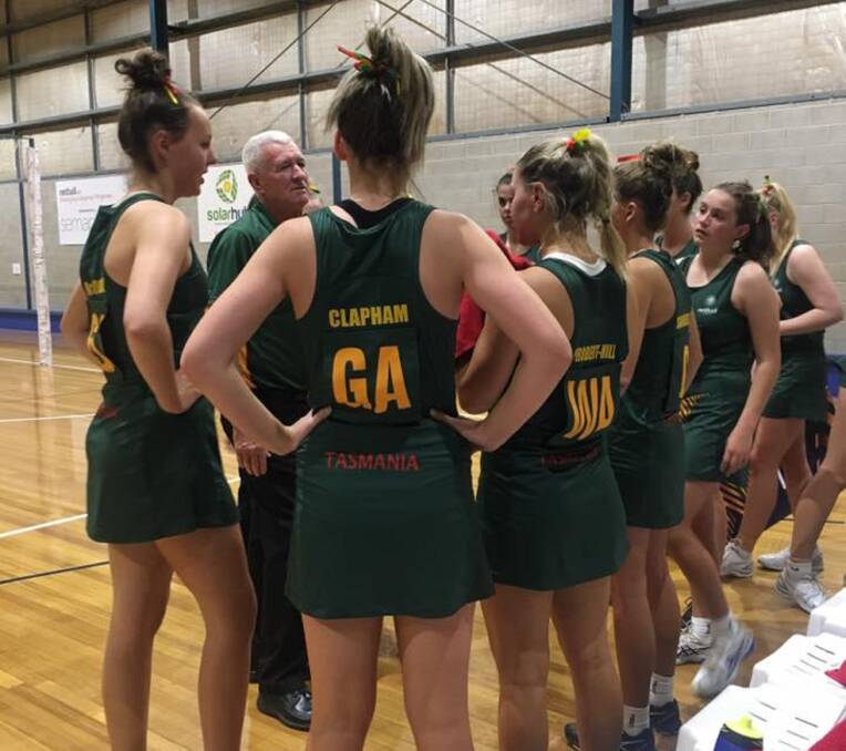STRATEGY: Tasmania's 17 and under netball coach Shane Fish talks to his players in a game against WA during the national championships. Picture: Netball Tasmania