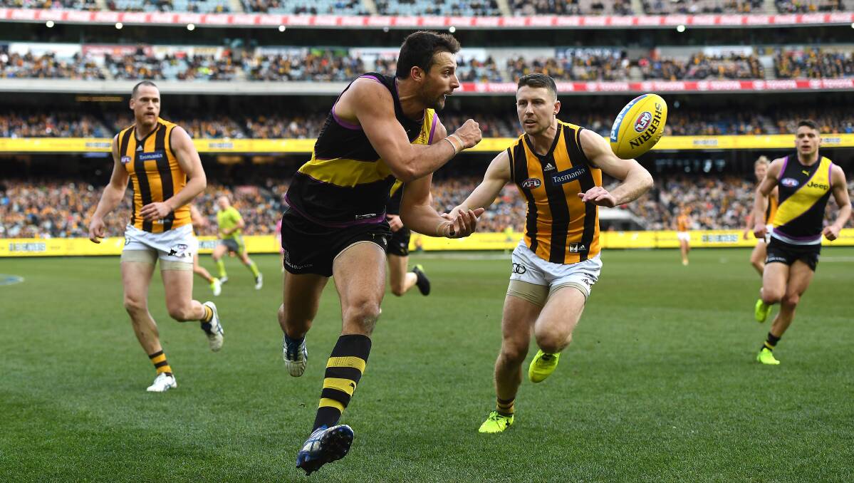 BIG YEAR: Toby Nankervis gets a handball away agaisnt Hawthorn earlier this year. Nankervis will have the challenge of trying to out-muscle Sam Jacobs on Saturday. Picture: AAP