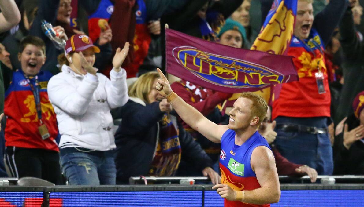 HAPPY DAYS: Clarence's Josh Green celebrates a major in Brisbane's win over Essendon. Pictures: Getty Images