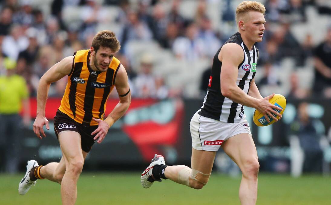 ON THE RUN: Devonport's Grant Birchall gets after Collingwood's Adam Treloar at the MCG on Sunday. Picture: Getty Images