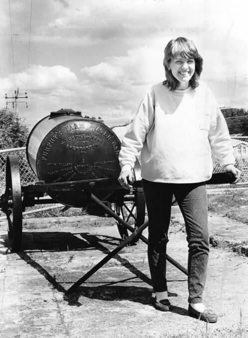 Sharon Walker, 19, of Launceston, with a Furphy water cart at the Grubb shaft Museum, Beaconsfield. Picture: Eddie Kerfoot, May 1989 