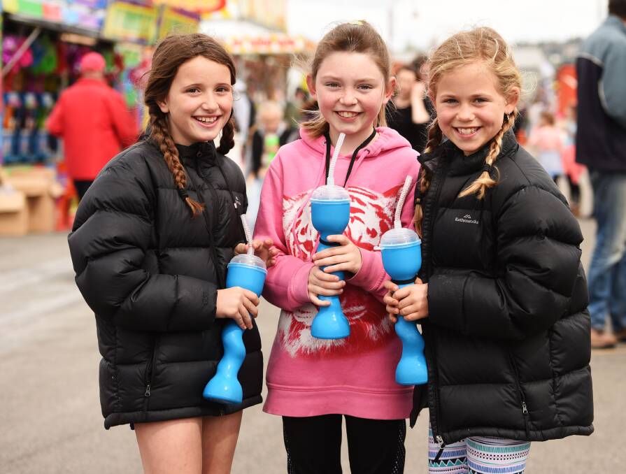 Erin Hughes, 9, Zoe Parkinson, 8, and Jorja Thomas, 9, of Launceston enjoy a drink at the end of the day.