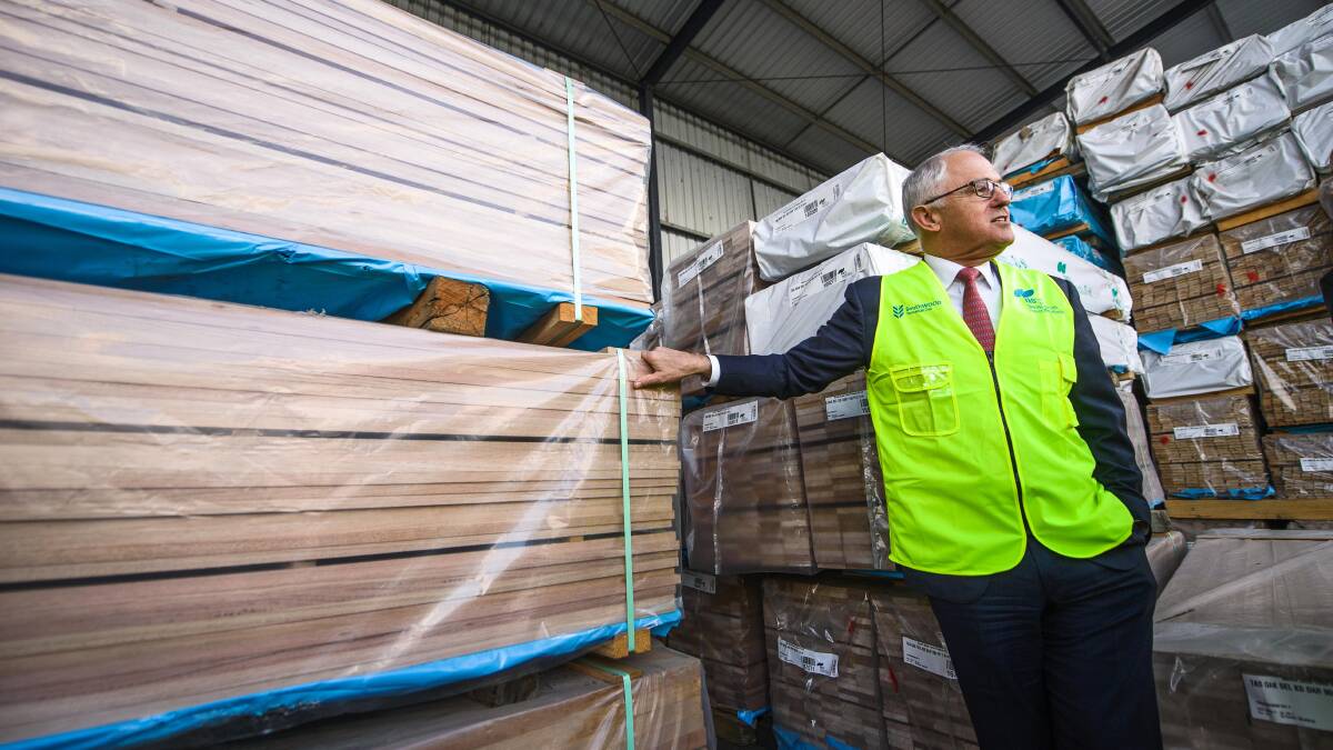 PM Malcolm Turnbull at Neville Smith Forest Products in Mowbray as the federal and state governments re signed the Regional Forest Agreement. "When shooting big media events such as Prime Ministerial visits, there can be upwards of 20 photographers trying to capture stills and vision. To get this shot, I'm actually about one meter from the PM with an extremely wide lens. " Picture: Scott Gelston. 