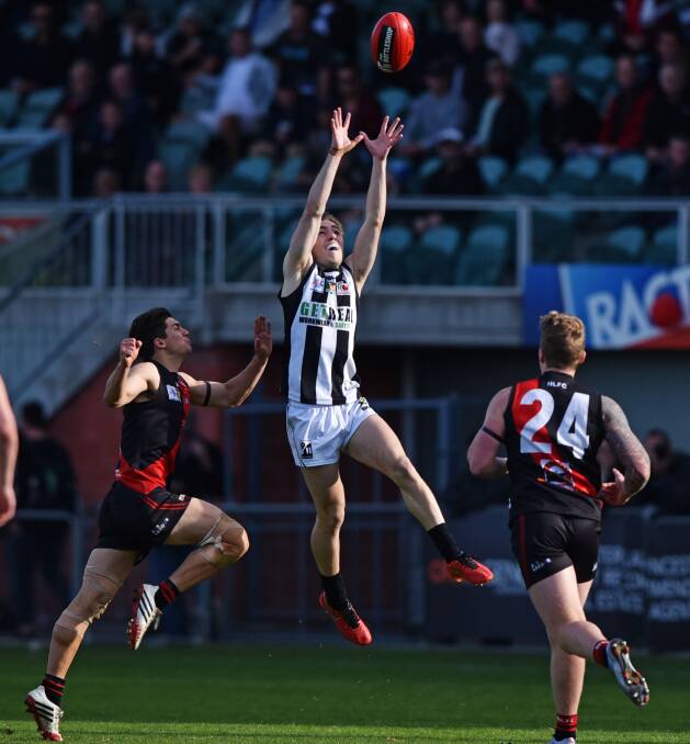 CENTERED: James Webb marks strongly for the Magpies between two approaching Bombers.