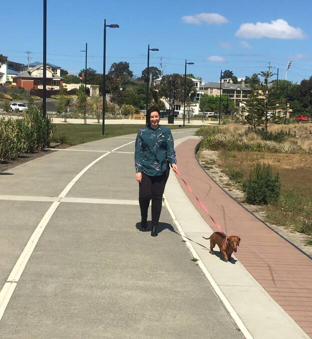Labor candidate Jo Siejka walks her dog Frankie in suburban Hobart on Sunday as the Pembroke by-election count continues.