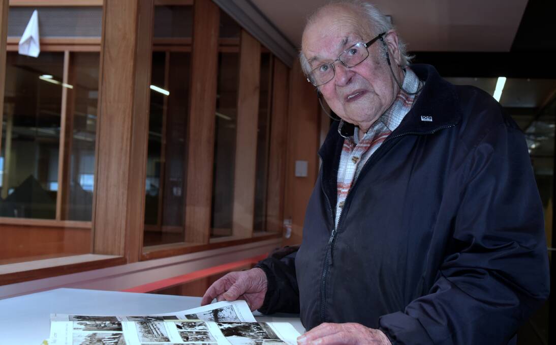 LOOKING BACK: Retired engineer Owen Ingles looks over a copy of The Weekly Courier which provided extensive coverage of the 1929 floods. Picture: Neil Richardson.