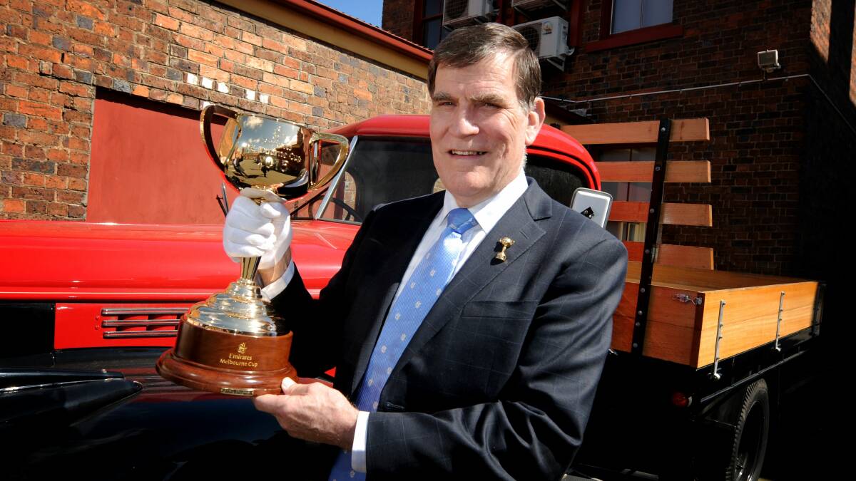 MELBOURNE CUP: Former Victorian chief steward and Melbourne Cup Ambassador Des Gleeson  with the Melbourne Cup at Boags in Launceston.