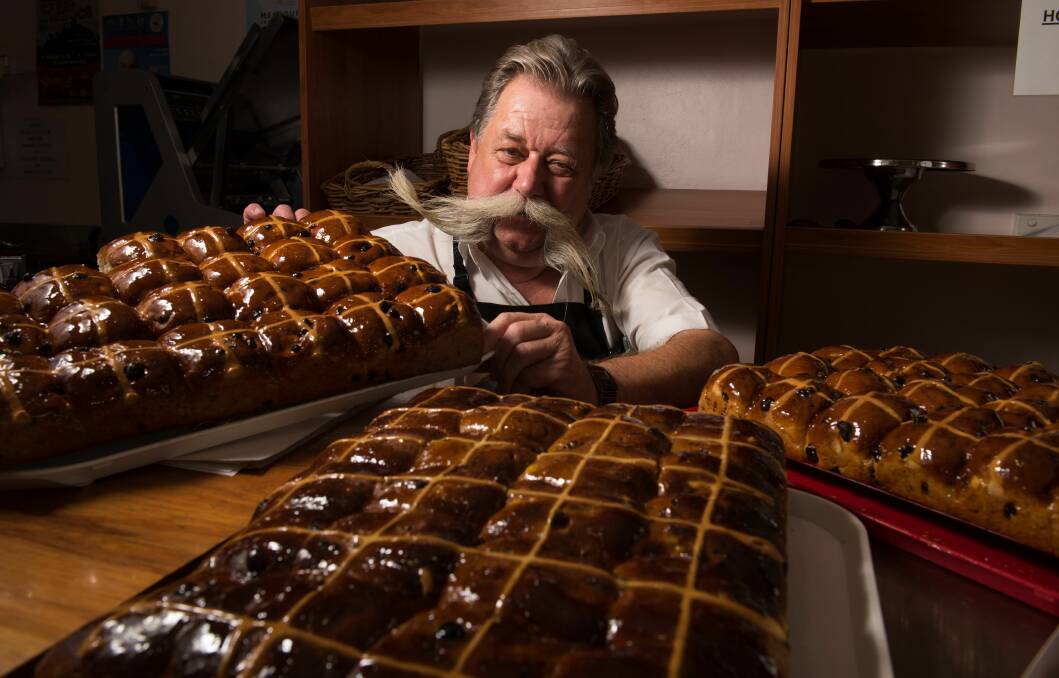 John Fahey, of Delicacy, with some of the 360 dozen hot cross buns baked at the Canning Street store. Picture: Scott Gelston.