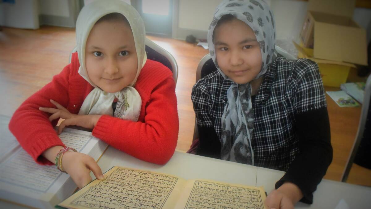 CULTURAL LEARNING: Zeynab Ashrafi and Faezeh Ashouri learning their mother tongue Dari at the community run Afghan Hazara language school to remain connected to their language and culture. Picture: Piia Wirsu