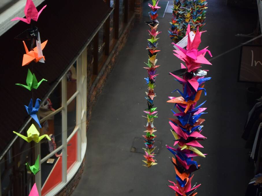 COLOURFUL: Cranes in the Old Brisbane Arcade. Anyone completing the task of making 1000 origami cranes is said to have a wish granted by the gods. 
