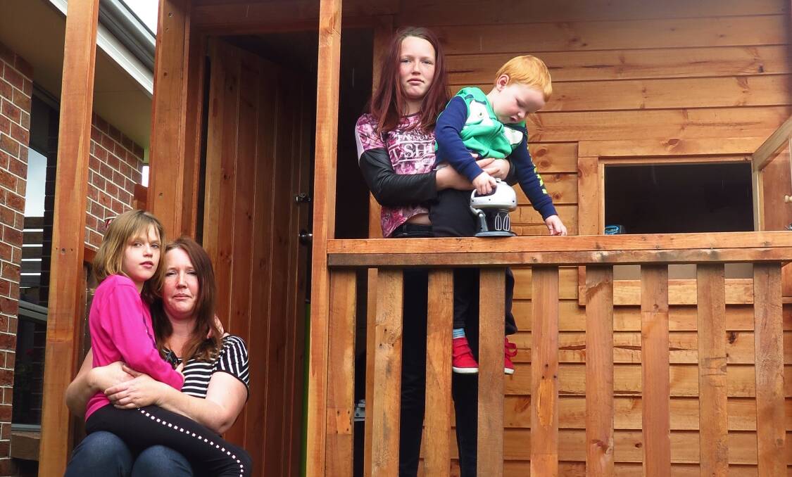 WORRIED: Lisa Atkins with her children Courtney, Phoebe and Jai with the offending cubby house. Courtney and Jai are disabled and the cubby is a treatment tool.