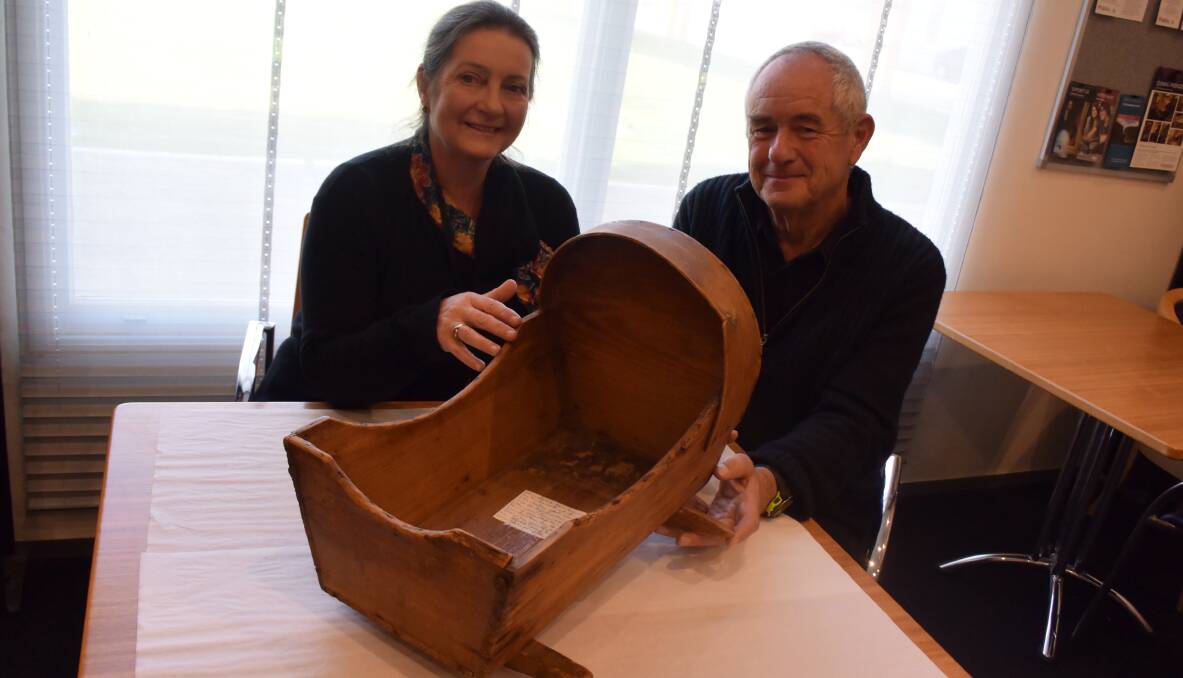 CRADLE: QVMAG's Louise James and donor Philip Pond examine an 1800s convict-made cradle that is giving a peek into a different understanding of the convict era. Picture: Piia Wirsu