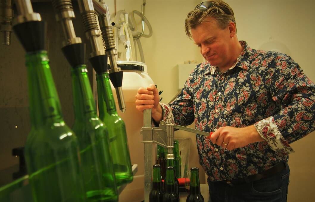 HISTORIC BEVERAGE: Stephen Wilkins bottling and capping the latest batch of mead in his meadery at Dilston. Pictures: Piia Wirsu