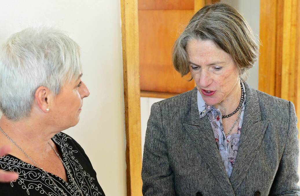SHARING: Caveside resident Julie Paul shared her story and showed Governor of Tasmania Kate Warner the photos of her flood-affected property, which still needs repairs. Picture: Phillip Biggs