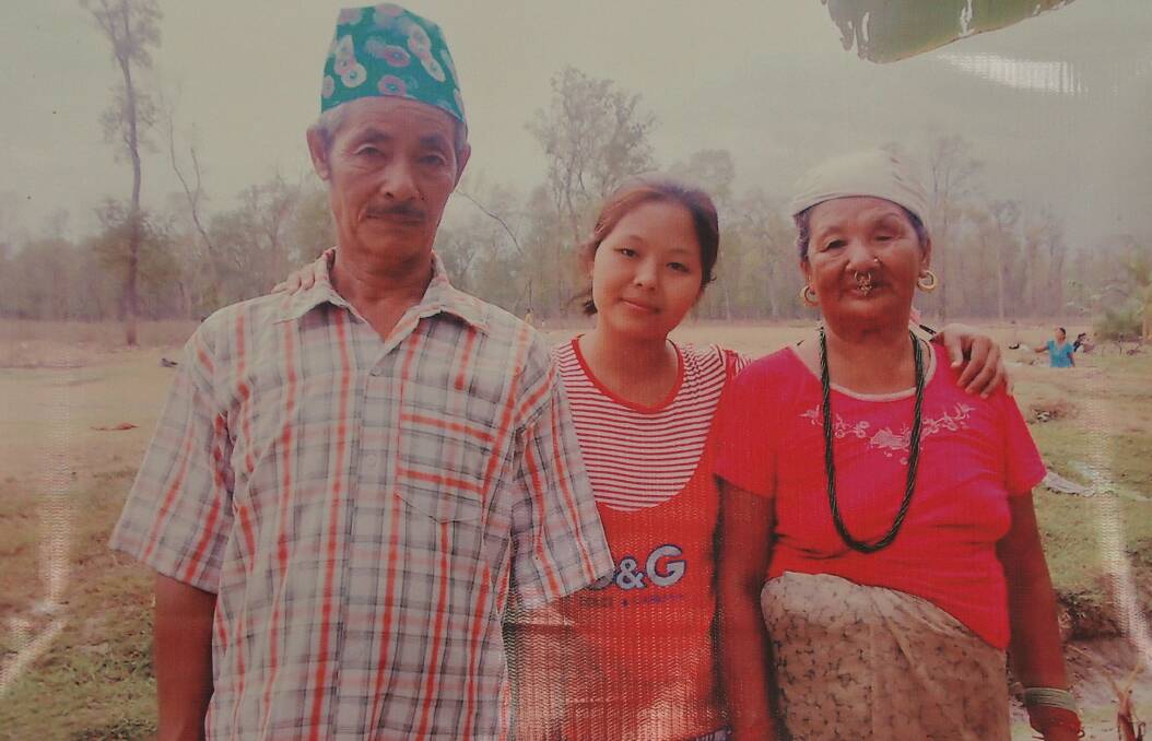 Prity with her parents in Nepal, where she lived in a refugee camp for two decades.