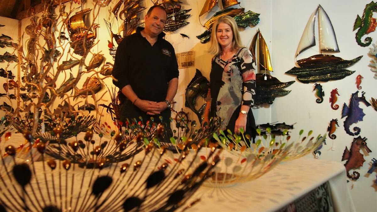 CREATIVE: Tom and Gail Malik in the gallery that has been described as "Aladdin's cave", filled with Mr Malik's metal art. Picture: Piia Wirsu