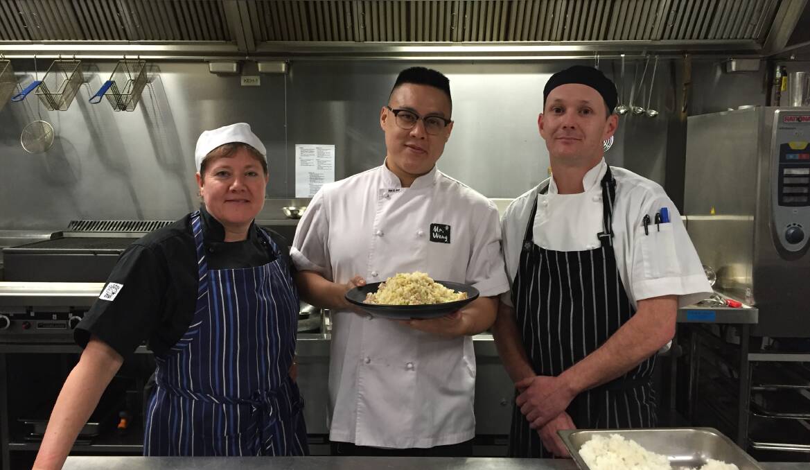 TEACHING MOMENT: Chef Dan Hong (middle) with third year students Sharon Cameron and Mark McClelland. Picture: Holly Monery.