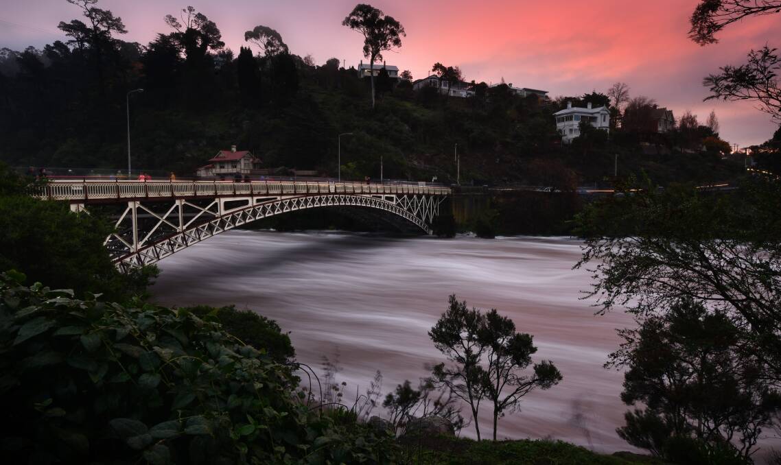 JUNE FLOODS: Sightseers flocked to see the spectacle of the floods at King Bridge as a stunning sunset broke through the skies over Launceston. The floods were testing for Northern Tasmanian councils. Picture: Scott Gelston 