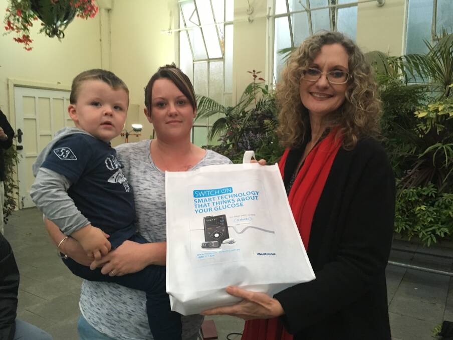 LIFE-CHANGING: Two-year-old Justin Haywood and his mother Danielle Bosworth accept a new insulin pump from Sandy Astill, of the Rotary Club of Youngtown.