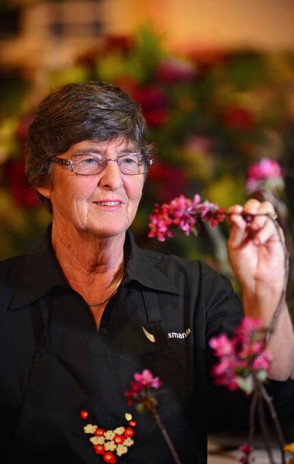 JAPANESE ART: Blooming Tasmania chair Jane Teniswood with an example of Ikebana, the Japanese art of flower arrangement, by Margaret Long. Picture: Phillip Biggs.