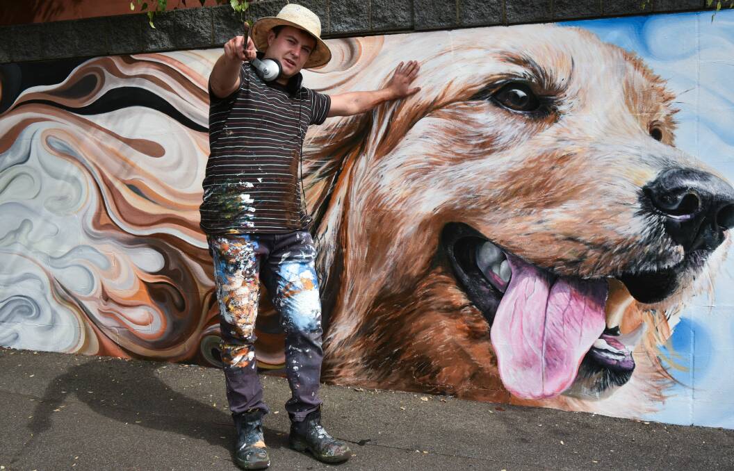 A LICK OF PAINT: Artist Josh Foley working on his mural on the outside of the Launceston Animal Medical Centre. The piece was commissioned to liven-up the front of the veterinary practice. Picture: Neil Richardson 