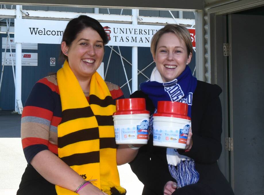 HELPING HAND: The Examiner editor Courtney Greisbach and deputy editor Rochelle Galloway prepared for donations from AFL supporters at Gate 7 of the University of Tasmania Stadium. Picture: Neil Richardson