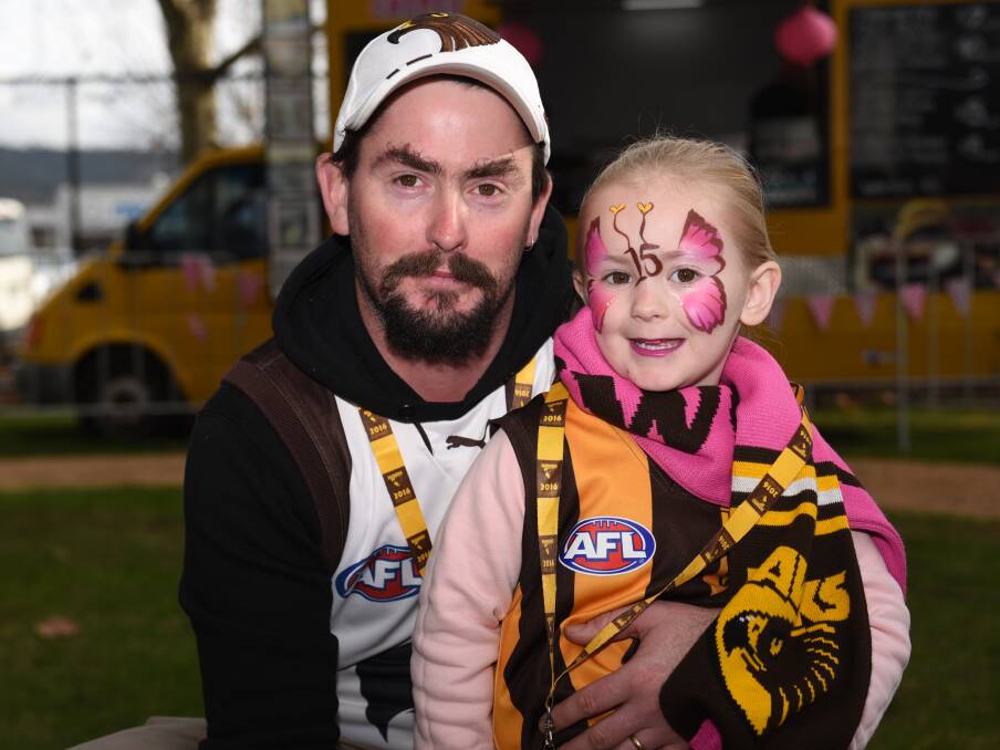 FIFTEEN FAVOURITE: Adrian and Isabella Pyke, 3, of Longford. Isabella's favourite player is Hawthorn's Luke Hodge, whose number 15 was painted on her face.