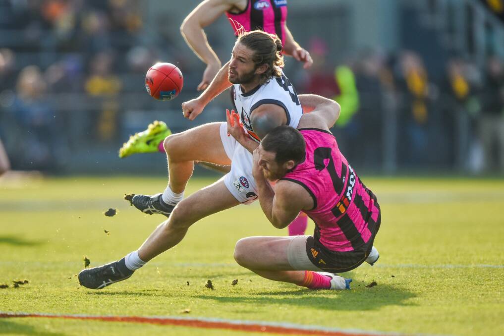 ROUGH AND TUMBLE: Hawks skipper Jarryd Roughead tackles GWS co-captain Callan Ward as the Hawks and Giants play at UTAS Stadium in July. Picture: Scott Gelston